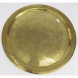 An Eastern circular large brass tray with overall engraved decoration,