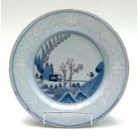 A Delft plate, 18th century, decorated in blue and manganese with a Chinese scene,