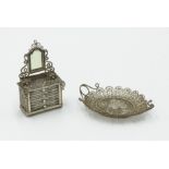 A late 19th century silver filigree dolls' house model of a dressing chest,