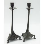 A pair of continental Art Nouveau pewter candlesticks, circa 1900, with leafy nozzles, twisted,