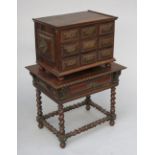 A table cabinet possibly Portuguese Colonial with an arrangement of nine drawers with pierced brass