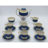 A Crown Staffordshire bone china coffee set, with blue and gilt borders and floral painted panels,