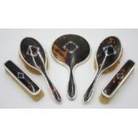 A five piece silver mounted tortoiseshell pique work vanity mirror and brush set by G W Lewis & Co,