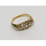 An 18ct gold Edwardian ring set with five diamonds. Condition report: Total weight 3.