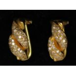 A pair of 18ct gold earrings each pave set with diamond ribbons.