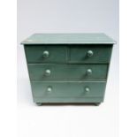 A Victorian painted pine chest of drawers, with two short and two long drawers, on bun feet,