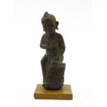 A carved wood Kris handle, 19th century, in the form of a boy, height 11.5cm.
