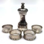 A solid silver pepper mill with thistle finial,