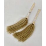 Two carved bone and horsehair fly whisks, the largest handle 18cm.