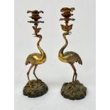 A pair of gilt-bronze and bronze Regency style candlesticks modelled as cranes,