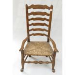 An ash and elm ladderback armchair, 19th century, with a rush seat, height 97cm.