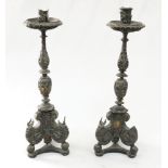 A pair of late 17th Century Italian ebonised and silver mounted candlesticks, with wide drip pans,