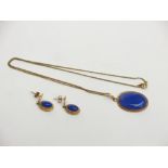A blue stone 9ct gold mounted pendant and chain together with a pair of matching earrings.