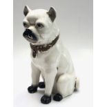 A continental ceramic model of a seated pug dog, circa 1900, height 36cm.