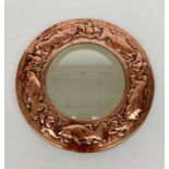 A Newlyn copper circular wall mirror, typically embossed with fish and wave motifs, diameter 32cm.