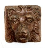 A saltglaze stoneware tile, 19th century, carved with the head of a lion, 14.5 x 14cm.