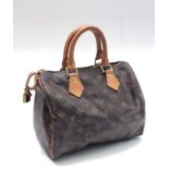 A Louis Vuitton monogram handbag, cow hide leather handles, canvas lined interior,