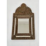 A Dutch embossed copper on brass hall mirror/brush cabinet, with arched crest, height 61cm.