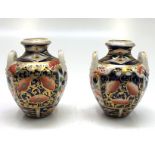 A pair of miniature Derby porcelain twin handled Japan pattern urns, height 8cm.