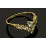 A diamond set wishbone 18ct gold ring. Condition report: Total weight 2.8g.