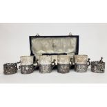 A set of six pierced silver cup holders with embossed cherub and acanthus decoration and with