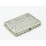 A Russian silver cigarette case by Alexander Piscaryev the heavy case chased with wild grasses and