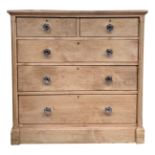 A pine chest of drawers, late 19th century, with two short and three long graduated drawers,