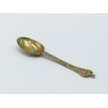 A Charles II silver gilt small trefid finial spoon the flat stem engraved to the front and back,