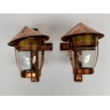A pair of Arts and Crafts copper and brass wall lights, with cruciform brackets,
