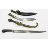 A 20th Century Gurkha Kukri knife, the brass hilt with lion pommel, in leather scabbard,