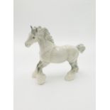 A Beswick white and grey dappled cantering shire horse, height 21cm, length 25cm.