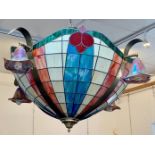 A pair of massive coloured glass light fittings, the domed shades with multicoloured leaded panels,