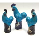 Three Chinese blue glazed models of cockerels, height of largest 25.5cm.