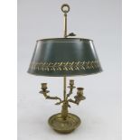 A French brass triple candle holder, 20th century, with adjustable green toleware shade,