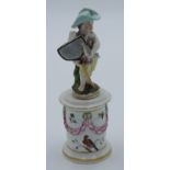 A Dresden porcelain figure of a cherub, modelled as a fisherman, on a cylindrical pillar base,