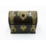 A Victorian brass bound coromandel casket, the arched cover and front with red glass roundels,