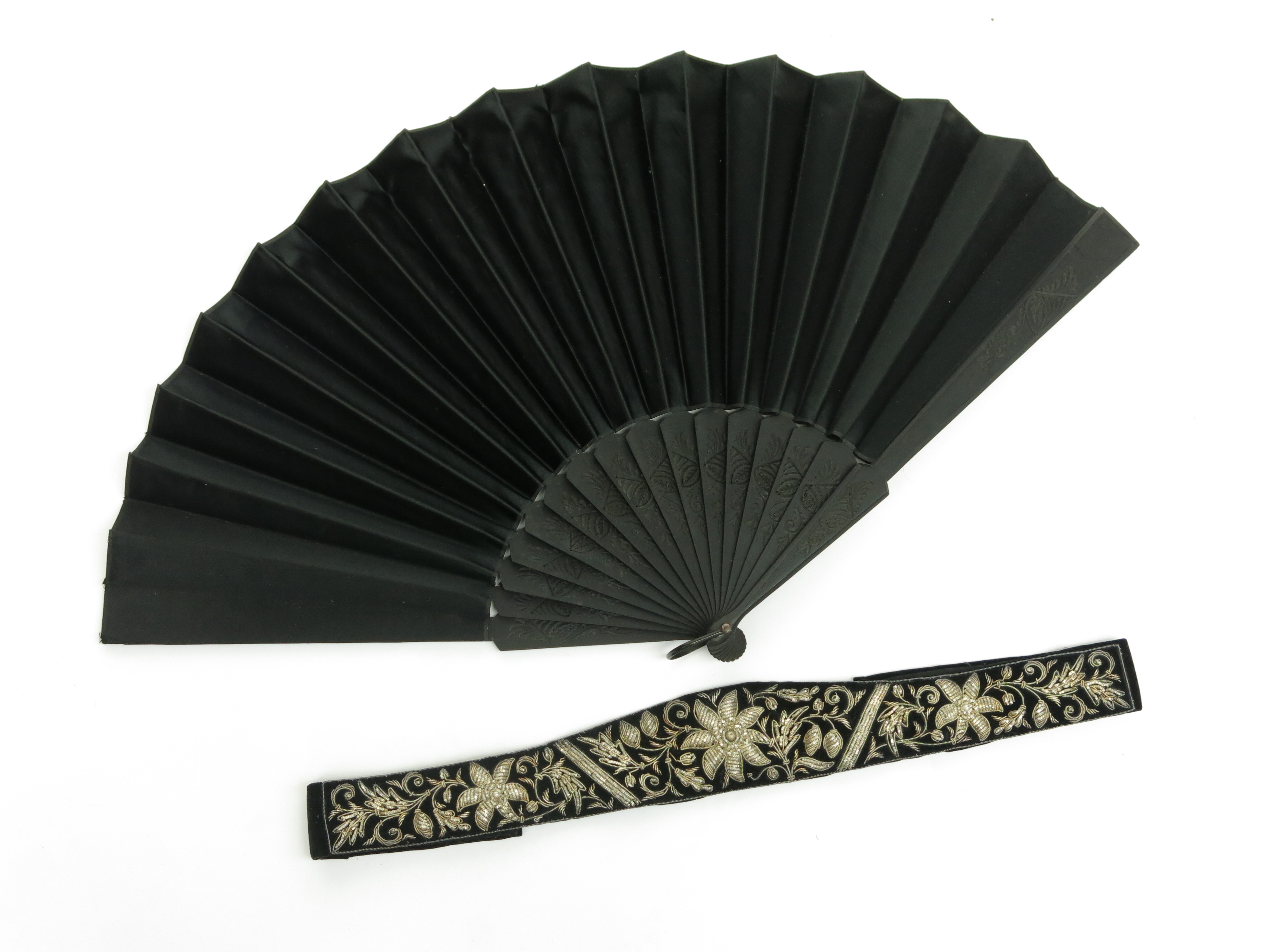 An Indian silver thread embroidered belt together with a fan.