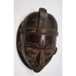 An African wooden Yoruba tribal mask, Nigeria, height 26cm width 18cm.