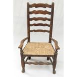 An ash and elm ladderback armchair, 19th century, with a rush seat, height 97cm.