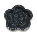 A Chinese black lacquered wooden tray, with mother of pearl foliate decoration, diameter 14cm.