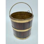 A George III brass bound mahogany bucket, with swing handle and brass liner, height 35cm,