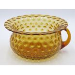 A Victorian amber glass chamber pot, with everted rim and overall dimpled decoration,
