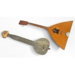 A Russian six stringed balalaika of typical shape, with inlaid decoration,