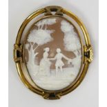 A Victorian large cameo brooch, the shell carved with two figures in a woodland glade.