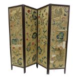 A mahogany embroidered folding screen, late 19th century each panel decorated with birds,