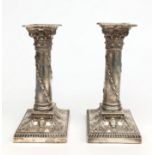 A pair of Adam style Thomas Bradbury & Sons filled silver candlesticks,