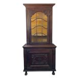 A continental oak display cabinet, 19th century, with a single glazed door,