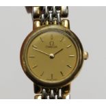 An Omega quartz ladies stainless steel and gilt De Ville No. 53623714 wristwatch on Omega bracelet.