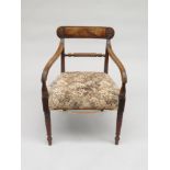 A mahogany open armchair, early 19th century, with a padded seat on turned tapering legs,