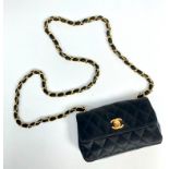 A Chanel black satin quilted evening bag, with turn-lock logo,
